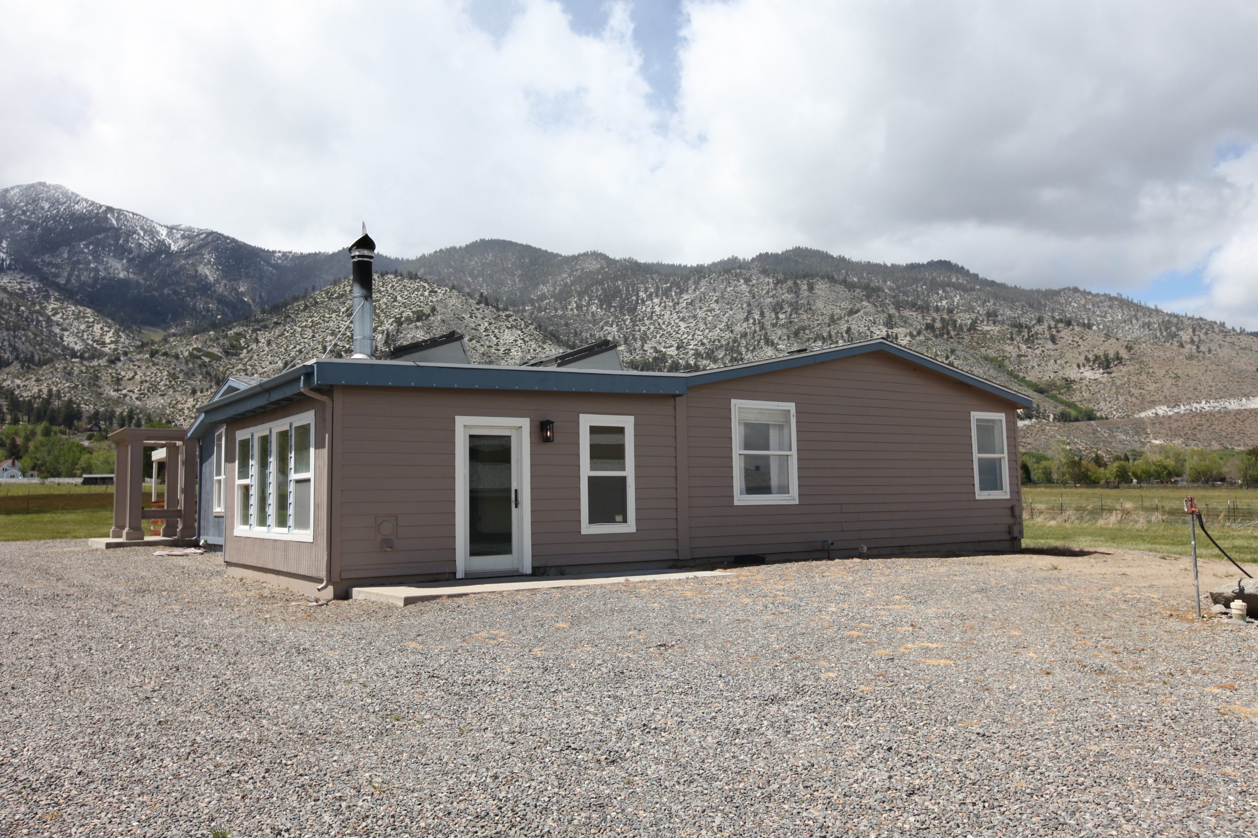 East side of house from gravel parking area with Sierra Nevada mountains