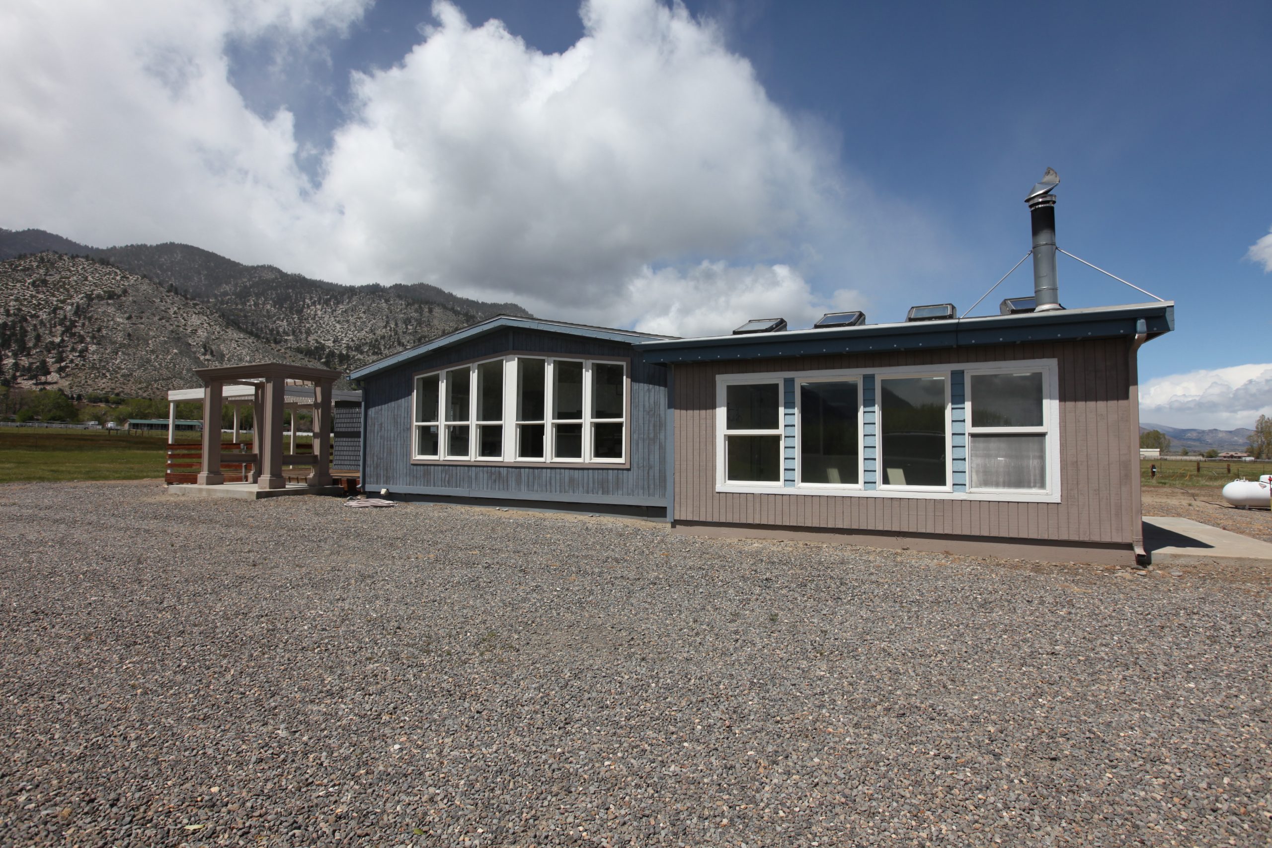 Front of house viewed from gravel parking area